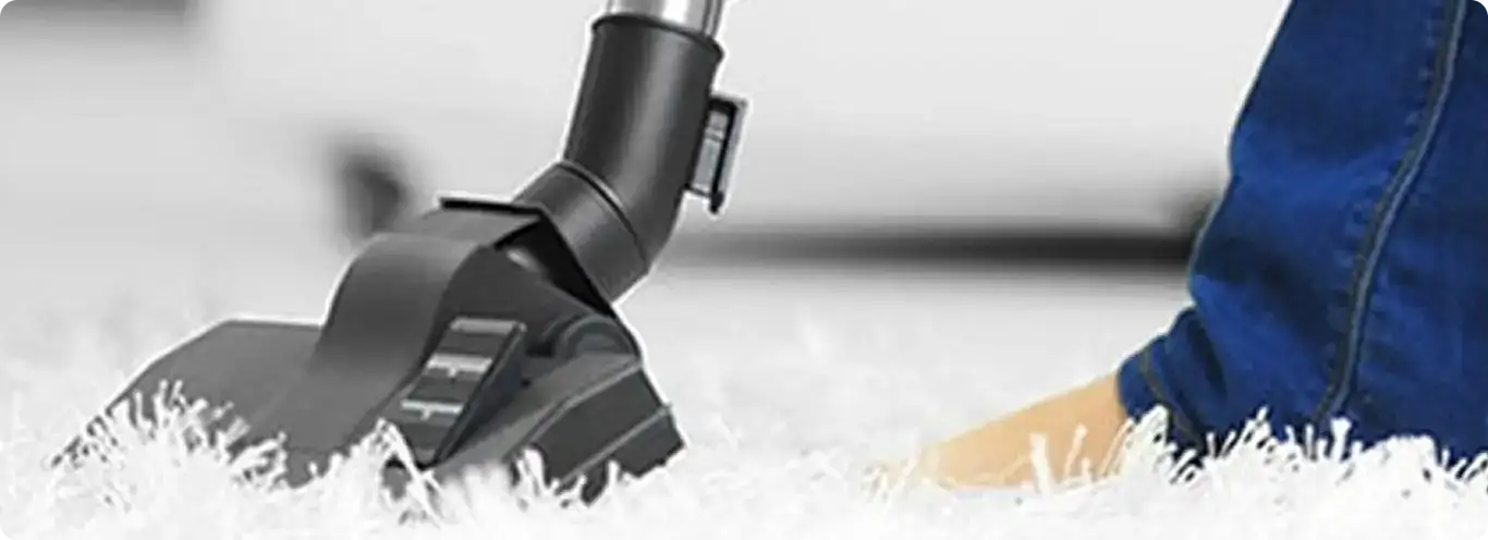 Close-up of a professional vacuuming a white carpet in Reynoldsburg.